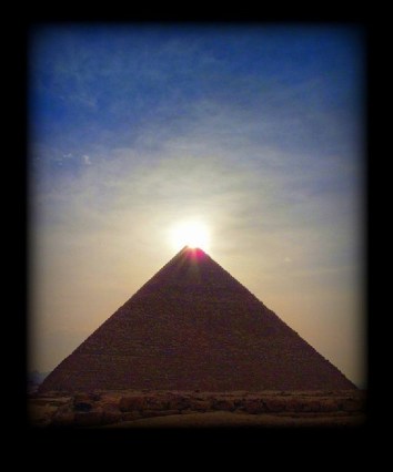 great pyramid giza with sunlight at the top